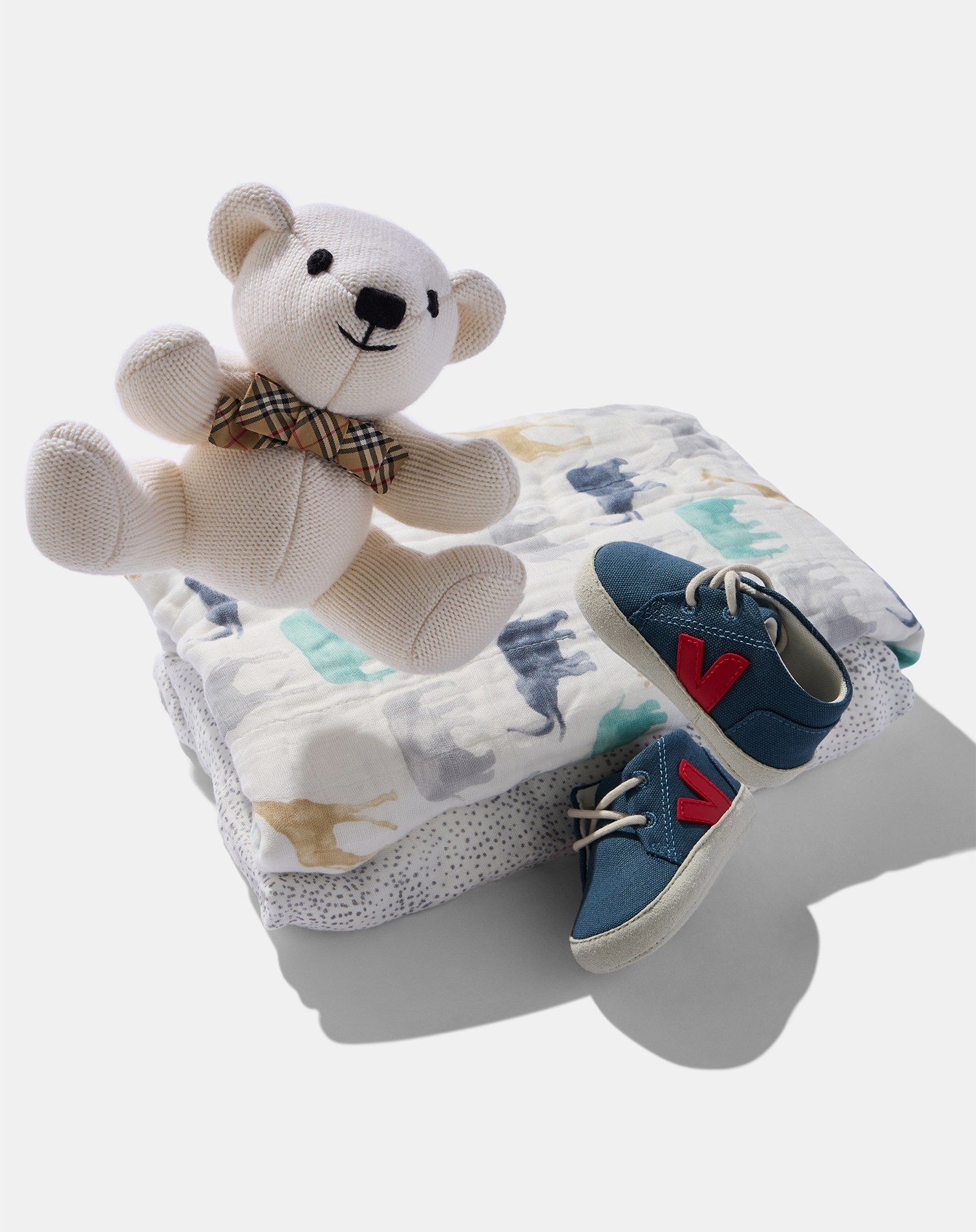 Burberry teddy bear, printed blankets, veja baby shoes