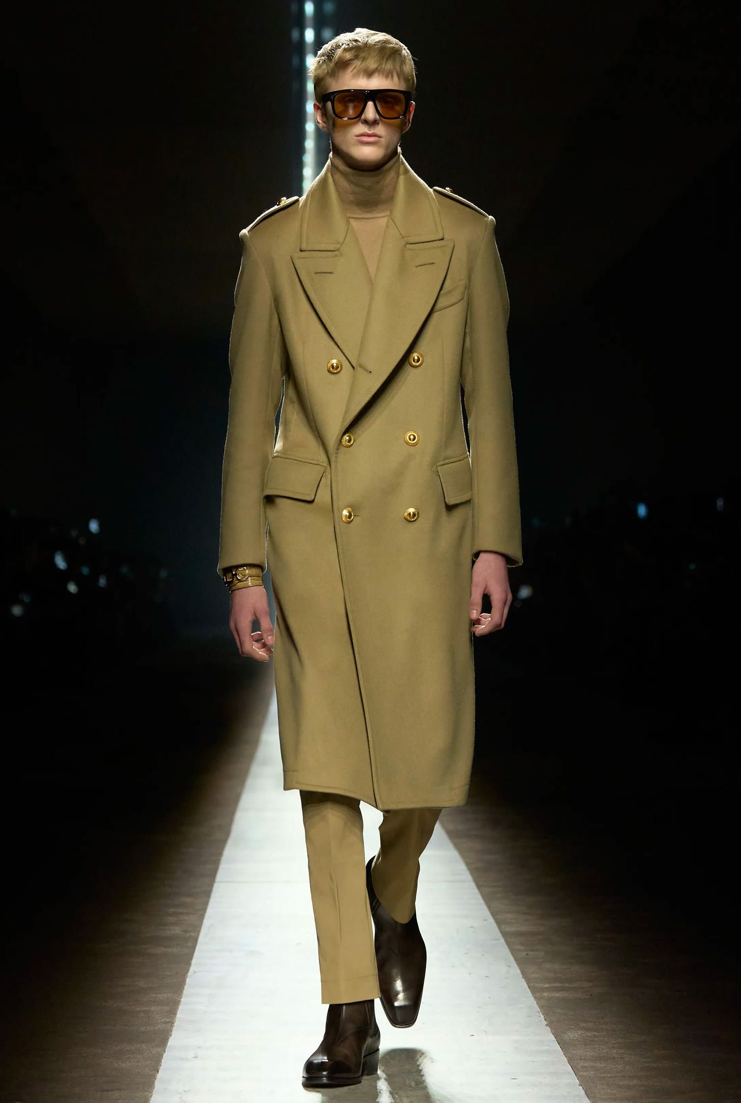 Tom Ford runway look of olive green monochrome outfit with a long coat and sunglasses