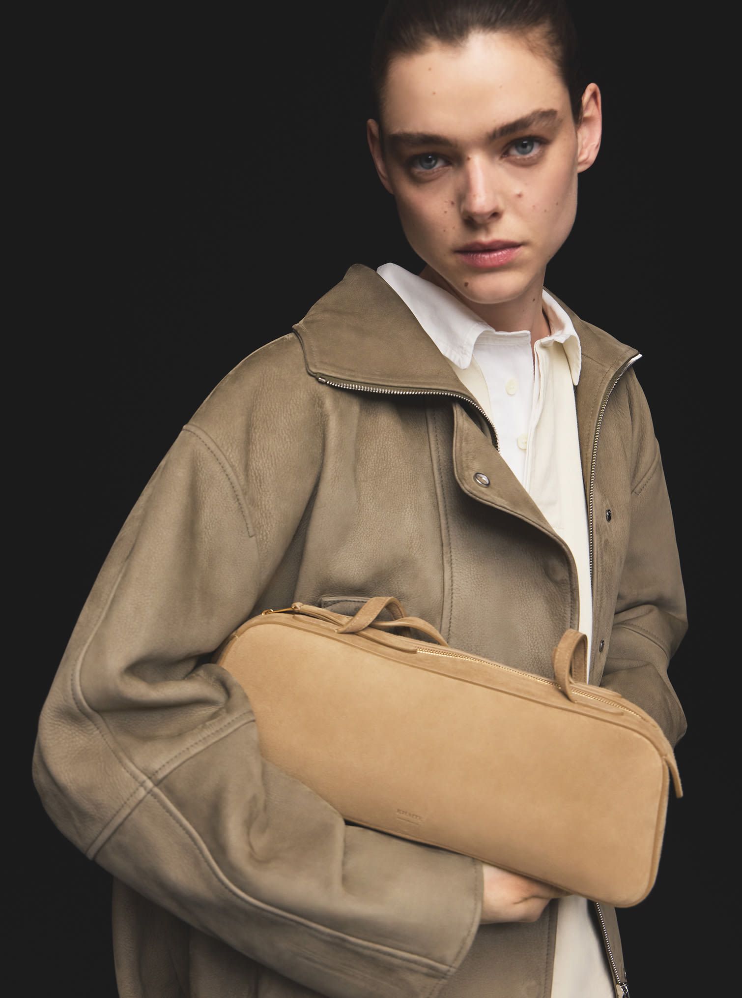 Women look with leather jacket, white polo t-shirt and camel suede leather handbag