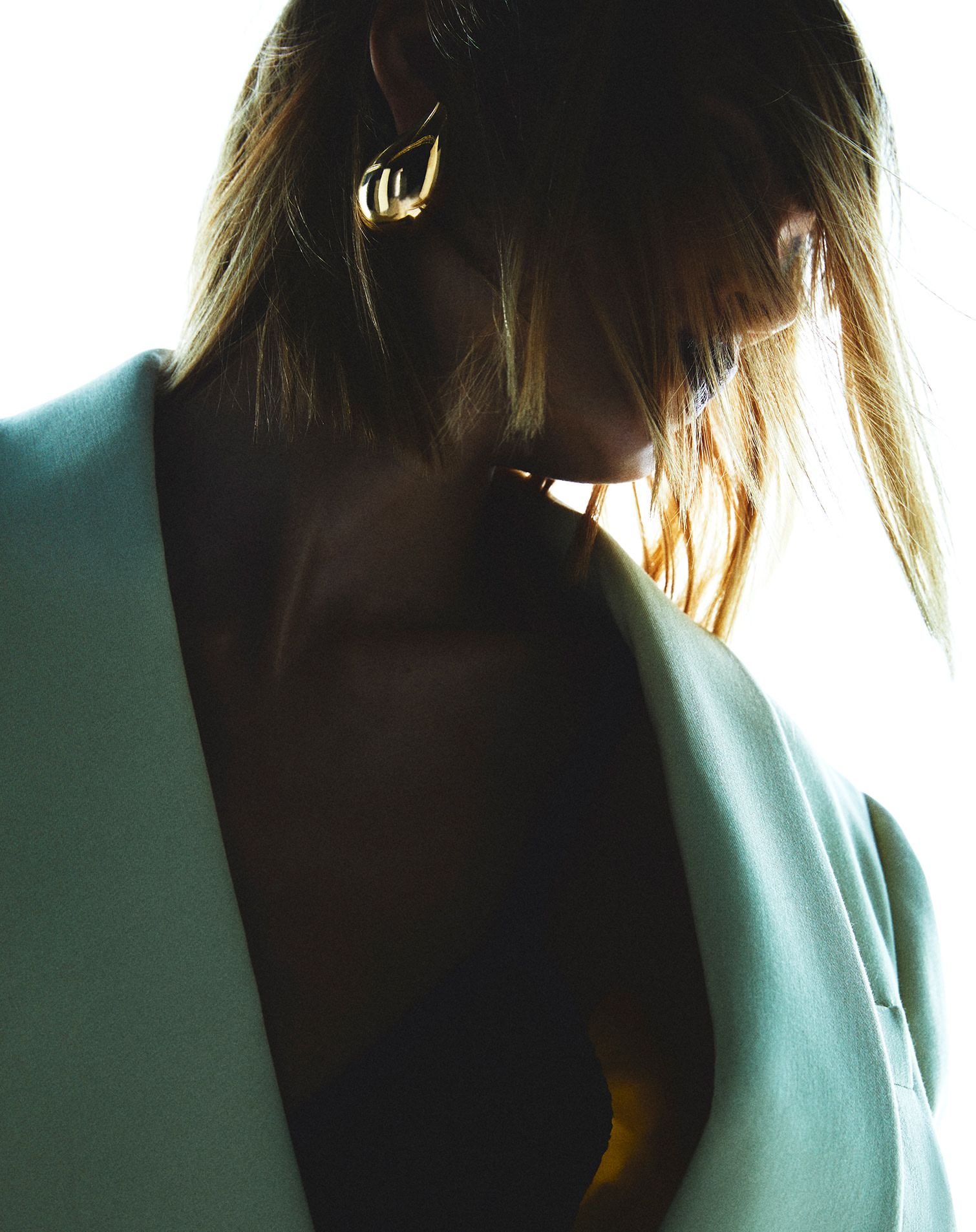 lady in the dark with a pair of golden earrings