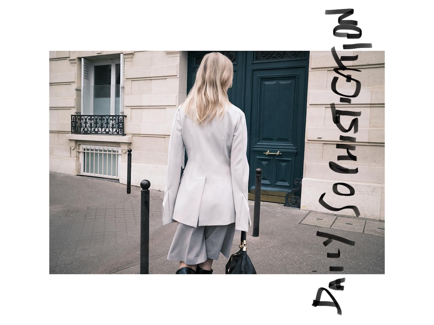 Girl walking away from camera with Sportmax blazer, MM6 Maison Margiela tailored short and Chloé foulard leather bag.