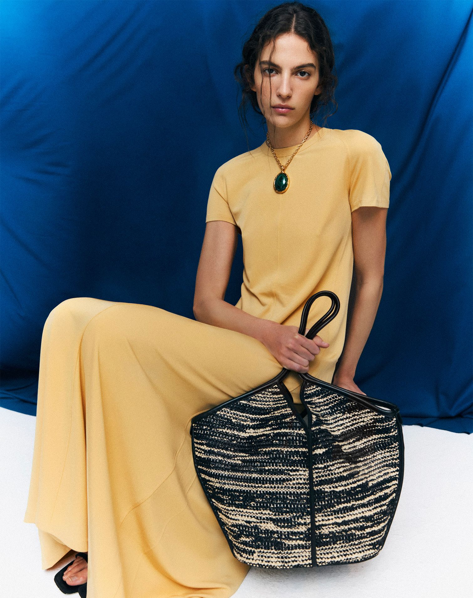 Model with long chain and big stone charm